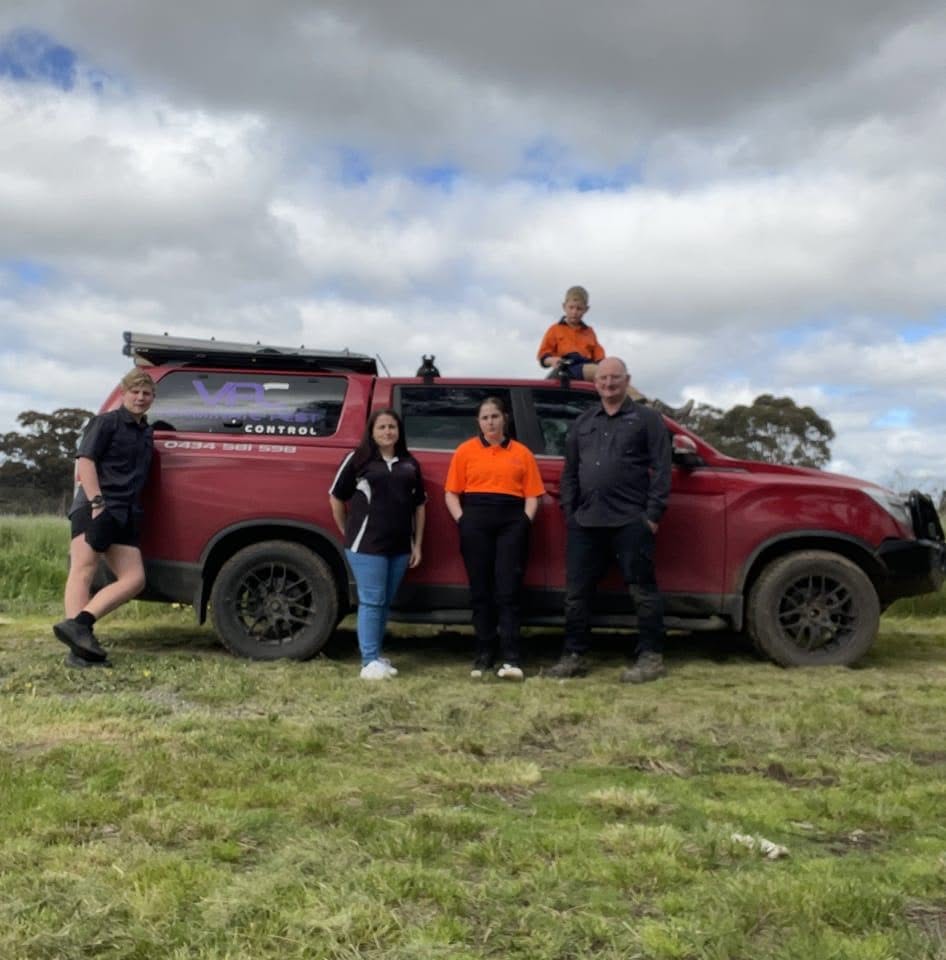 The Verminate team with their branded red vehicle